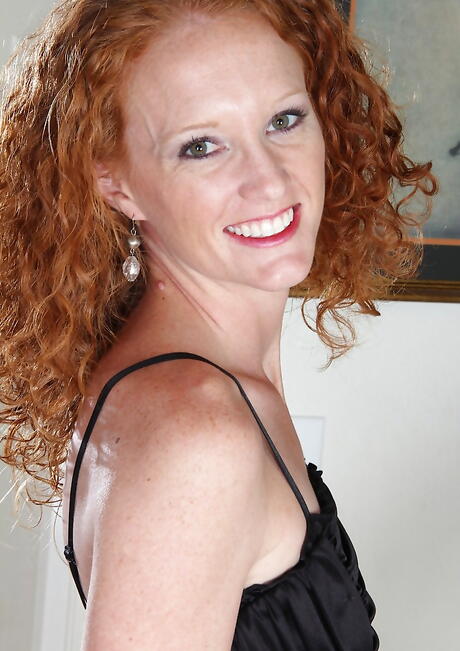 Sultry redheaded mature Ande exposes tiny tits and pussy 